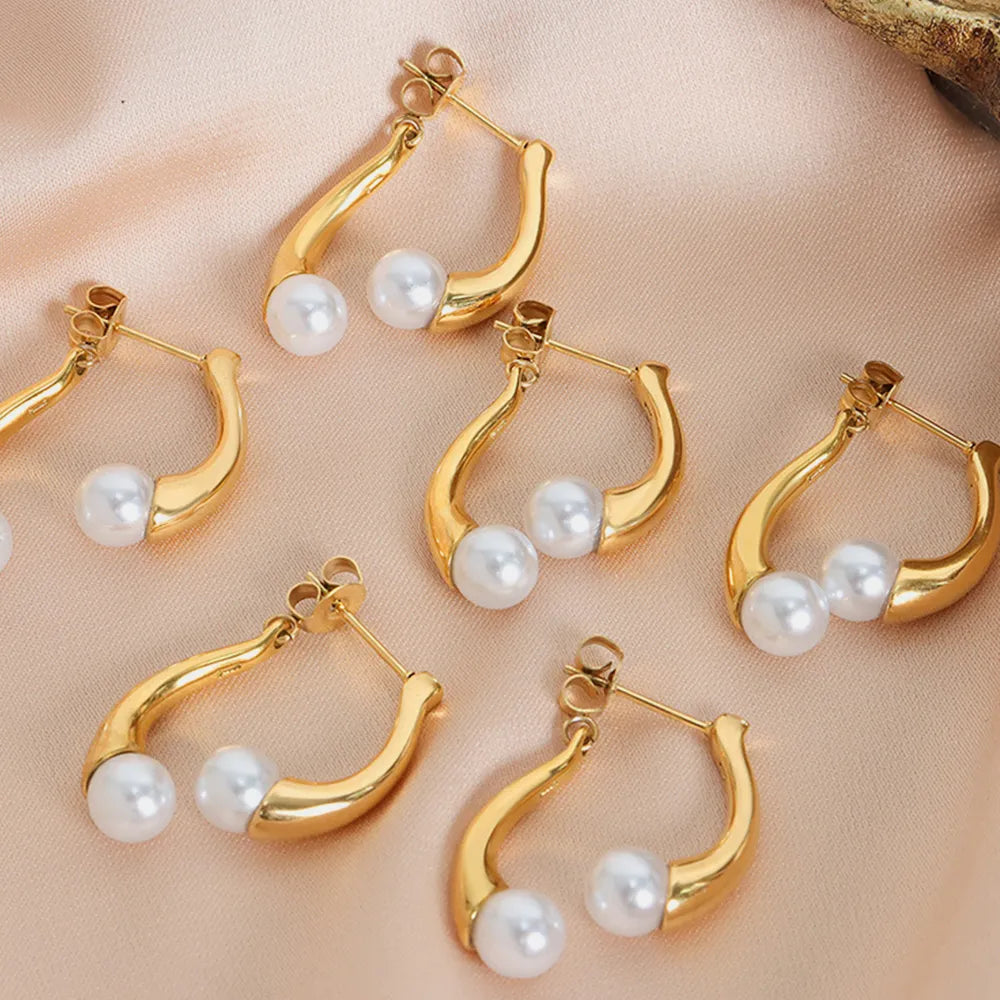Gold sculptural drop hoop earrings with pearls