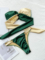 Two-tone bandeau bikini in forest green and gold with ring details and a tie-front top.