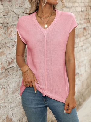 Blush pink seamed knit sleeveless v-neck top with a casual fit.