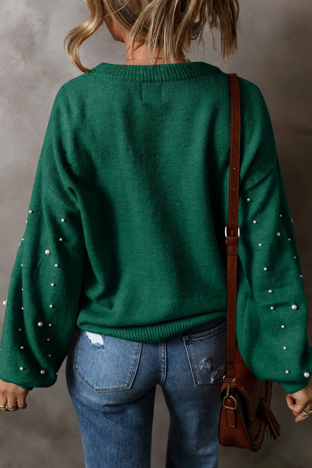 Dark Green knit sweater with pearl embellishments on the sleeves.