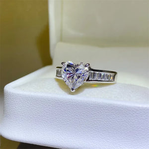 Silver ring with heart-cut moissanite and baguette stones