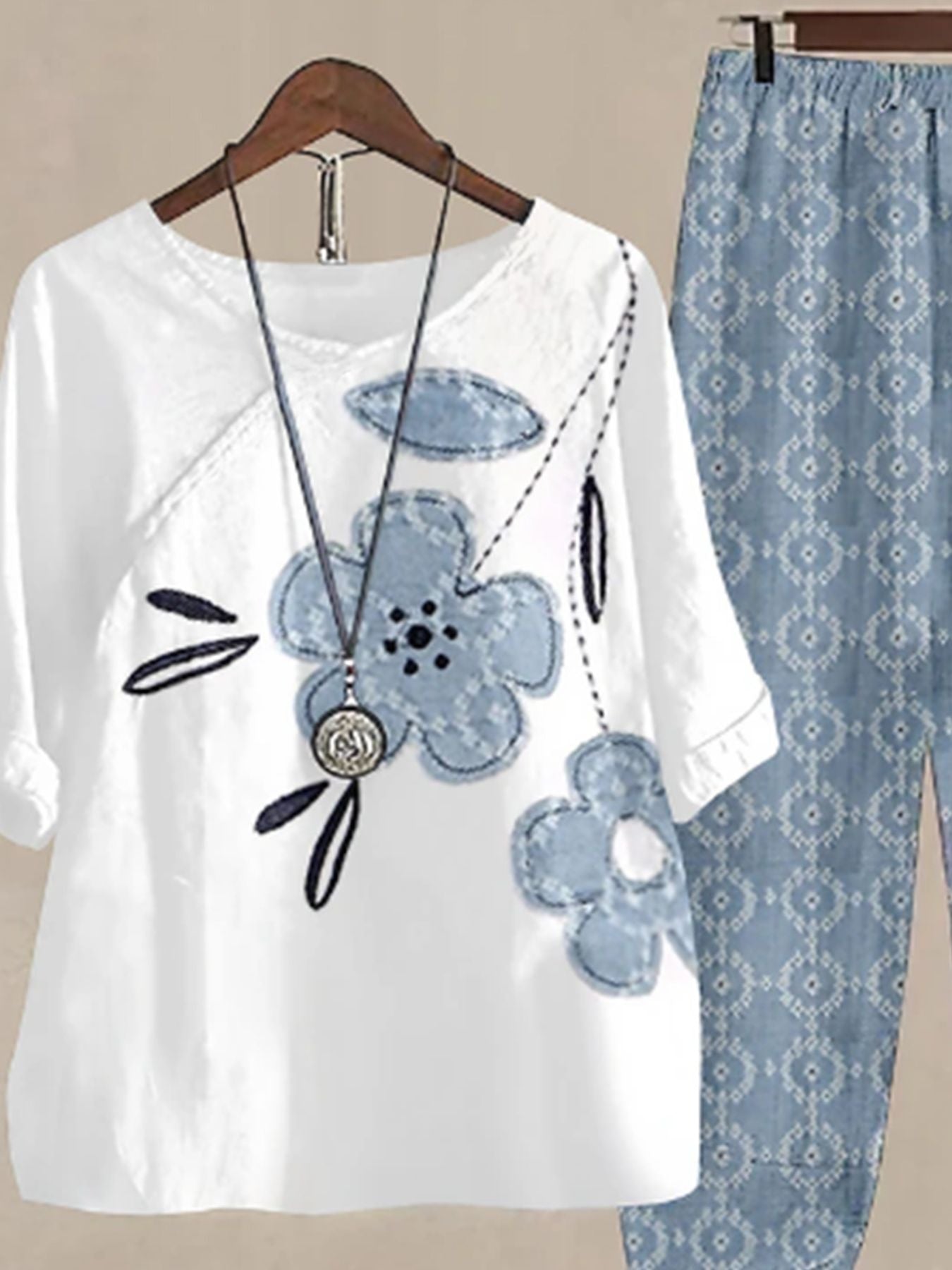 White floral print half sleeve top with blue denim-look flowers and matching patterned pants.