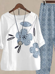 White floral print half sleeve top with blue denim-look flowers and matching patterned pants.