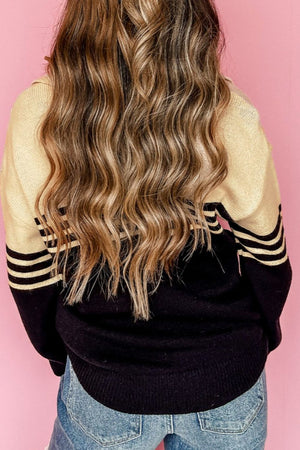 Varsity stripe knit polo sweater in black with beige accents and black stripes on sleeves.