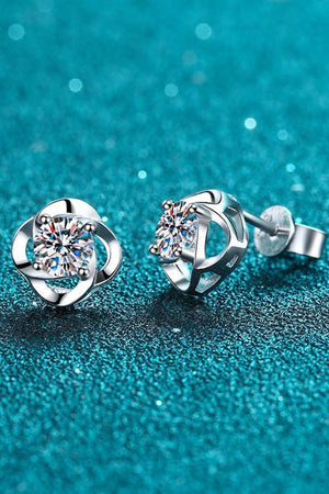 Silver four-leaf clover stud earrings with a central sparkling stone.