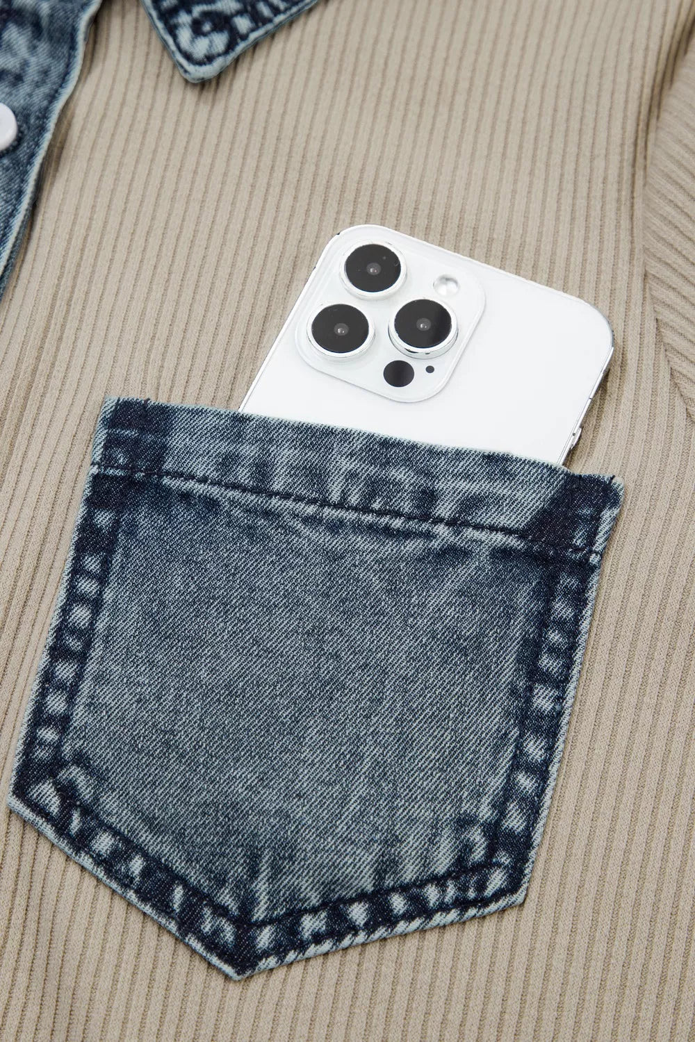 Ribbed knit mini dress in beige with denim pocket detail and a white phone.