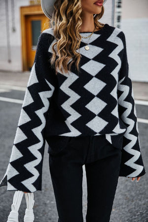 Black chevron knit pullover sweater with bell sleeves and a crew neck.