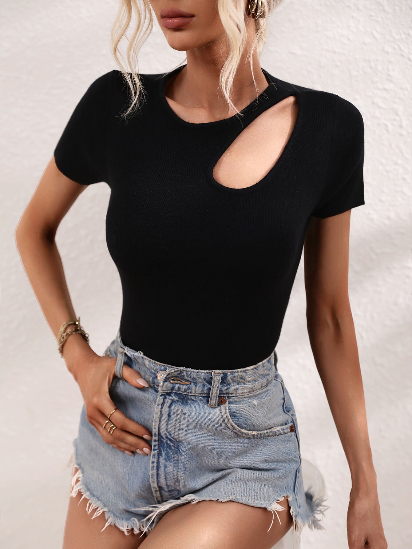 Black knit t-shirt with short sleeves and a chic cutout detail on the neckline.
