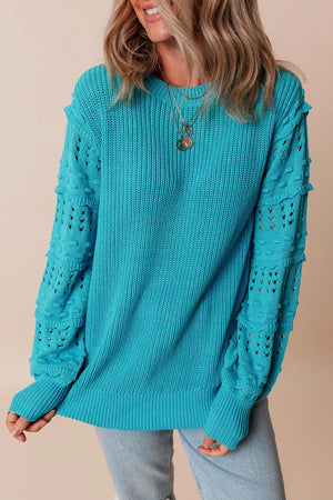Turquoise knit sweater with textured cutout sleeves and crew neck.