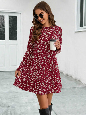 Deep red floral swing mini dress with long sleeves and round neckline.