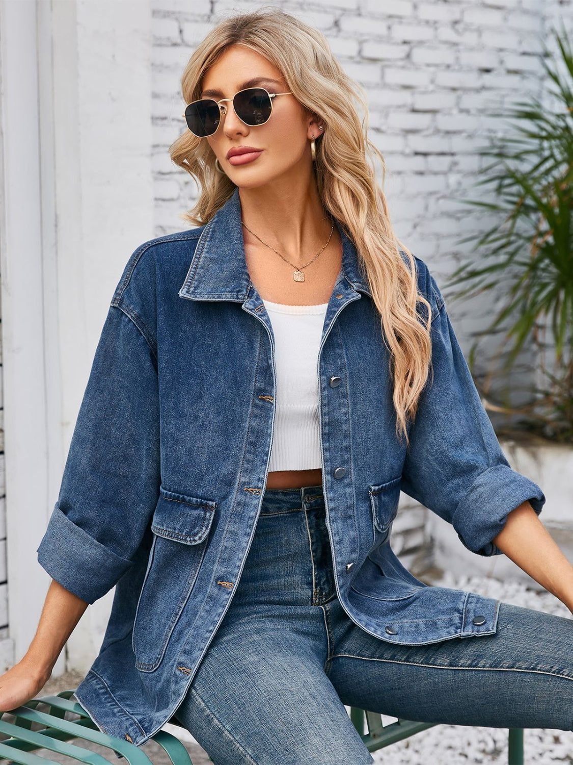 Chic denim button-up jacket in dusty blue with two chest pockets and cuffed sleeves.