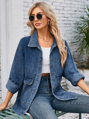 Chic denim button-up jacket in dusty blue with two chest pockets and cuffed sleeves.