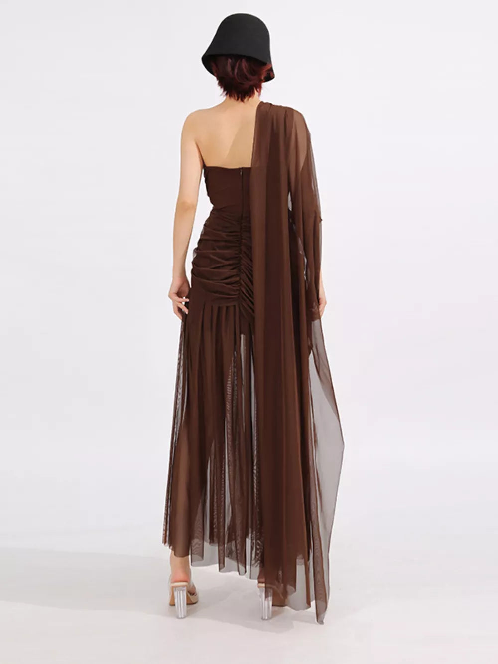 Brown draped one-shoulder maxi dress with ruched bodice and sheer skirt.
