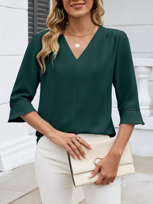 Dark green V-neck blouse with 3/4 sleeves and lace trim detail.