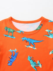 Orange toddler tee with skateboarding dinosaur print.
