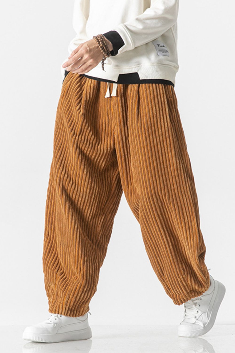 Relaxed fit corduroy wide-leg cargo pants in orange with a drawstring waist.
