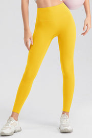 Yellow high-waist performance leggings with sculpting seams.