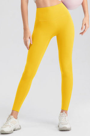 Yellow high-waist performance leggings with sculpting seams.