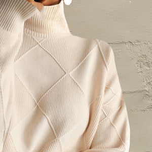 Ivory turtleneck pullover sweater with diamond knit pattern and ribbed texture.