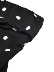 Black polka dot strapless wide-leg jumpsuit with ruched bodice detail.