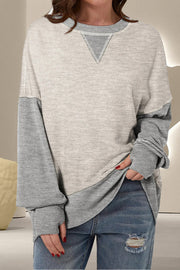 Chic Contrast Crewneck Sweatshirt in light gray and gray with V-stitch detail.