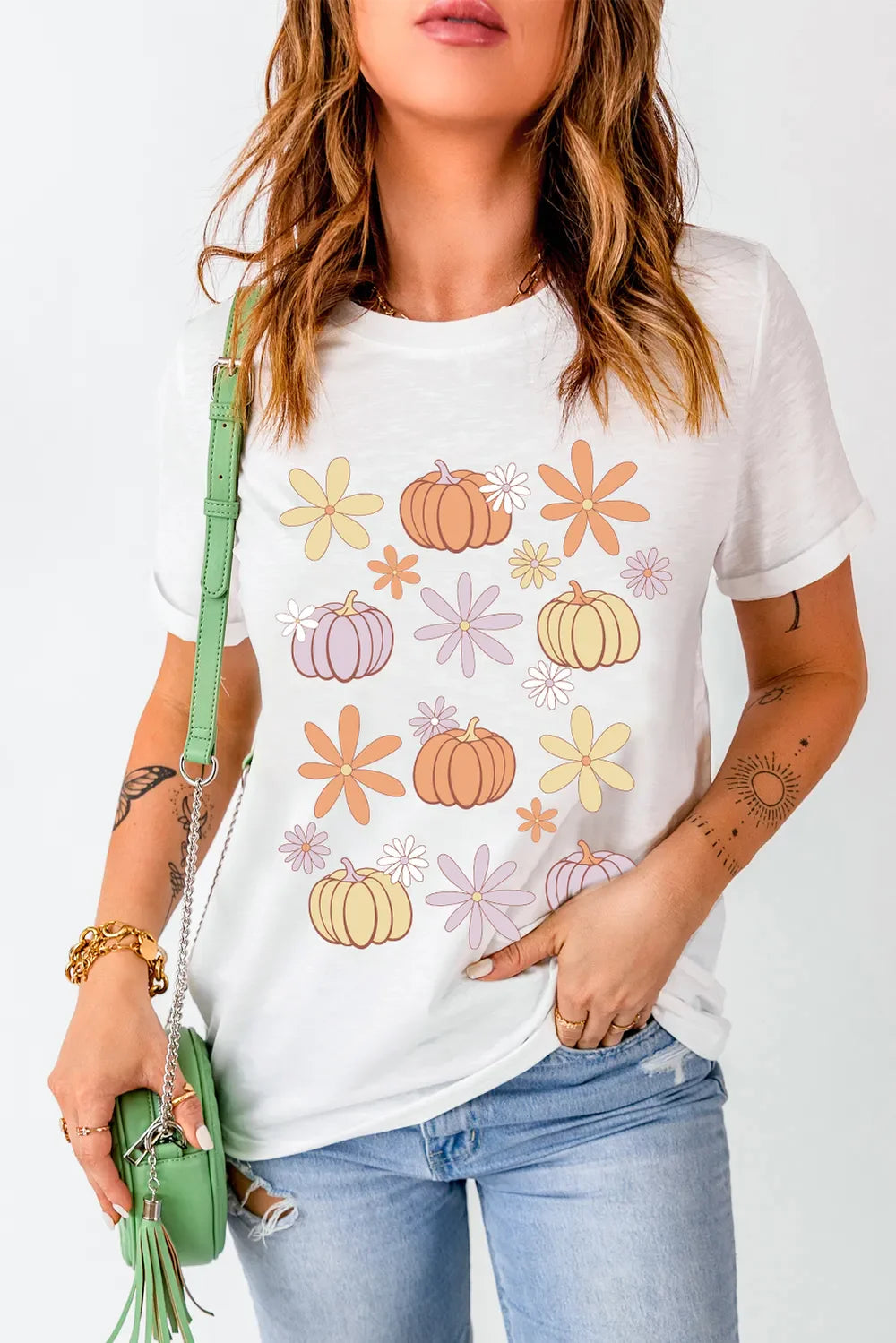 White t-shirt with a groovy pumpkin and flower graphic print.