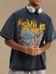 Washed black oversized graphic t-shirt with a colorful abstract design and text.