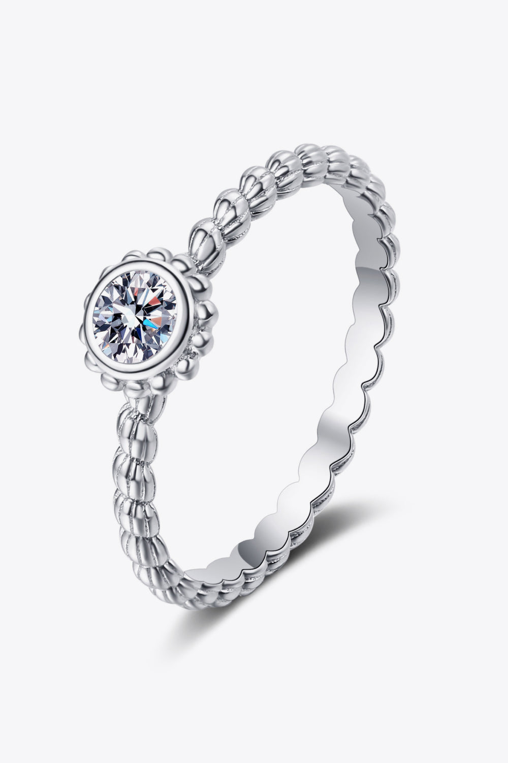 Silver beaded band ring with a moissanite solitaire stone and scalloped edge.