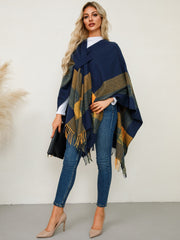 Navy asymmetric plaid fringe cape with a tie detail and fringed hem.