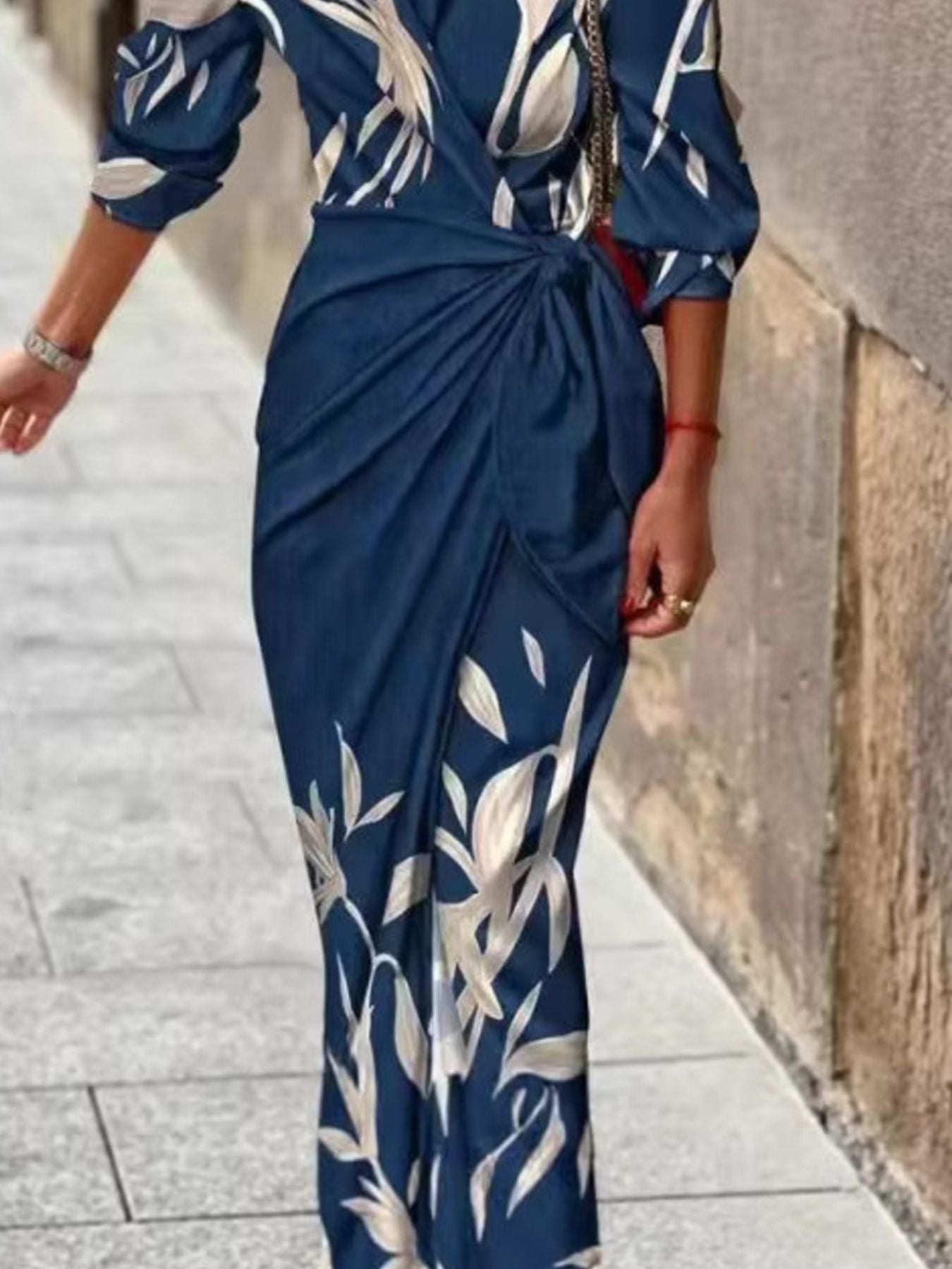 Belted wrap midi dress in navy with a light leaf print, featuring a knot detail at the waist.
