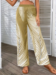 Palm print palazzo trousers in khaki with white palm leaf pattern and side slits.