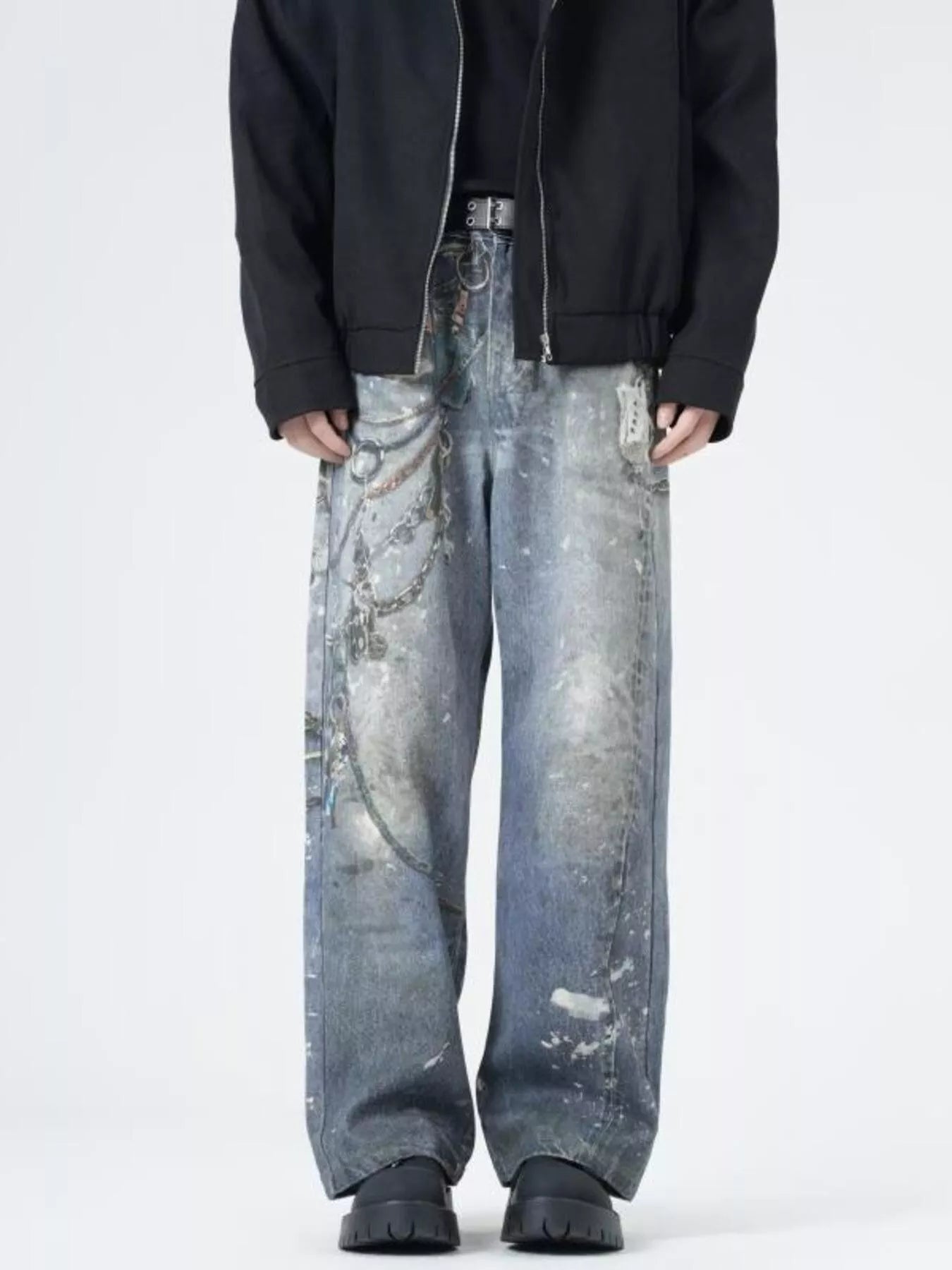 Men's wide-leg jeans in dusty blue denim with chain print and distressed details.