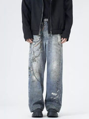 Men's wide-leg jeans in dusty blue denim with chain print and distressed details.