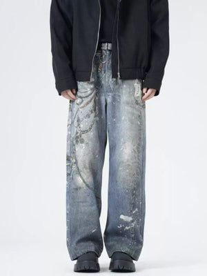 Men's wide-leg jeans in dusty blue denim with chain print and distressed details.