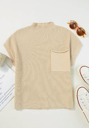 Ribbed knit mock neck top in cream with short sleeves and a chest pocket.
