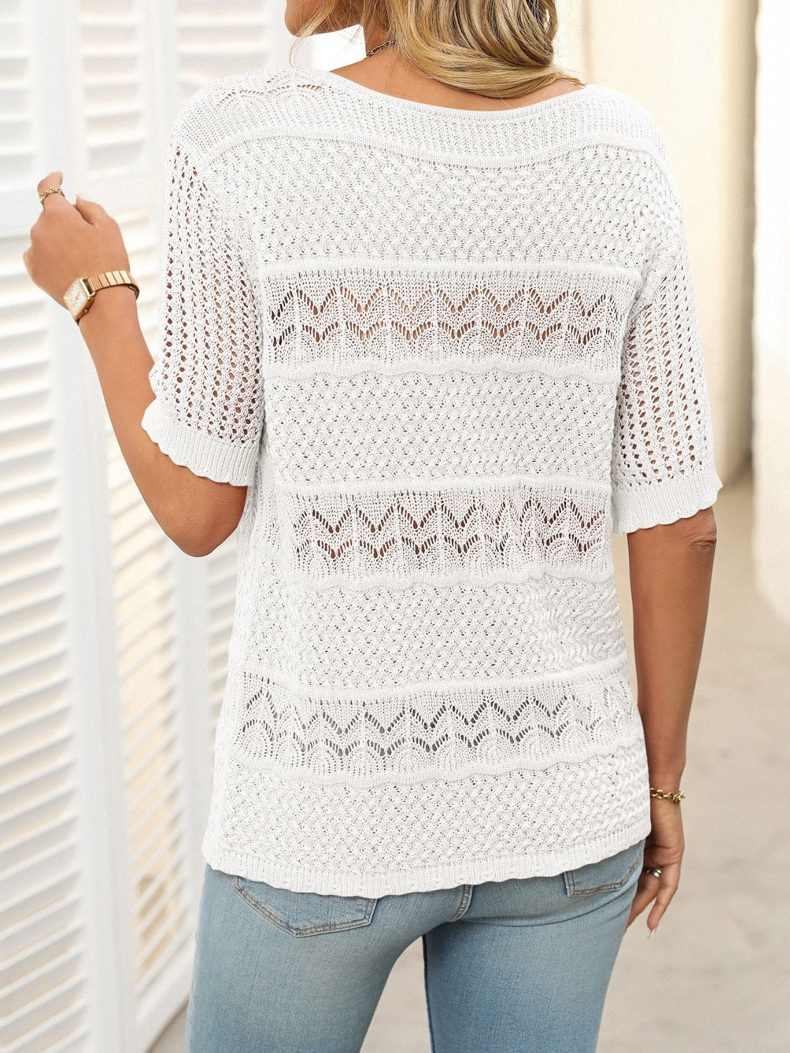 White knit sweater with half sleeves and openwork stripe details.