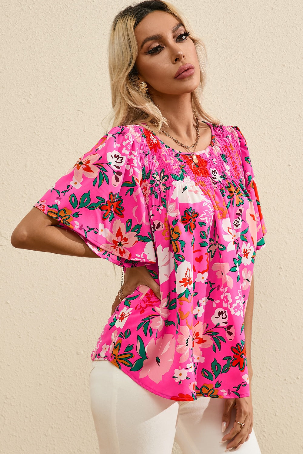 Hot pink floral blouse with smocked yoke and flutter sleeves