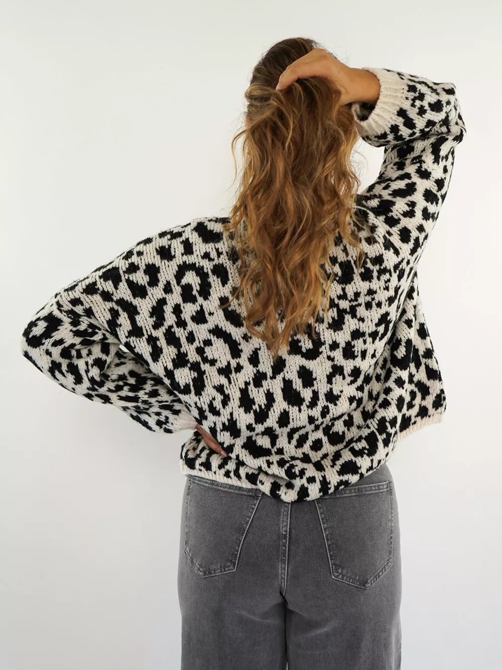Black and white leopard print cardigan with crew neck and long sleeves.