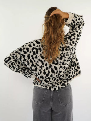Black and white leopard print cardigan with crew neck and long sleeves.