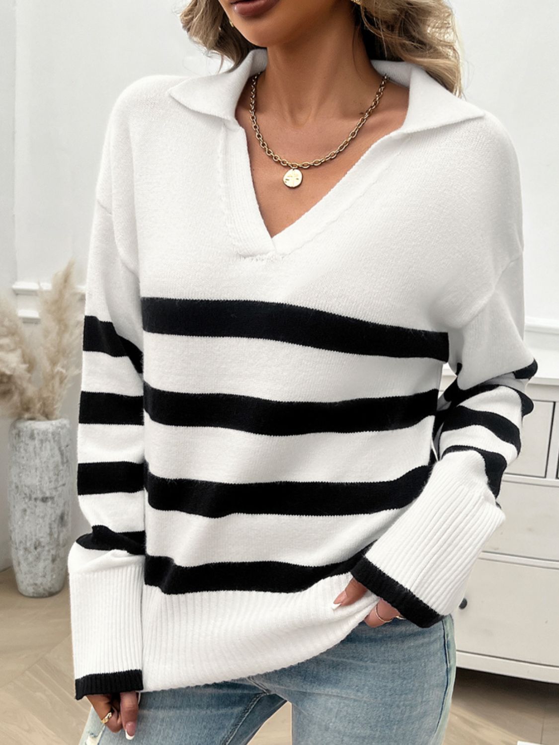 Bold stripe knit sweater with collar and v-neck in white and black.