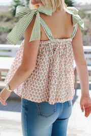 Playful floral peplum cami with green striped tie-straps and smocked back.