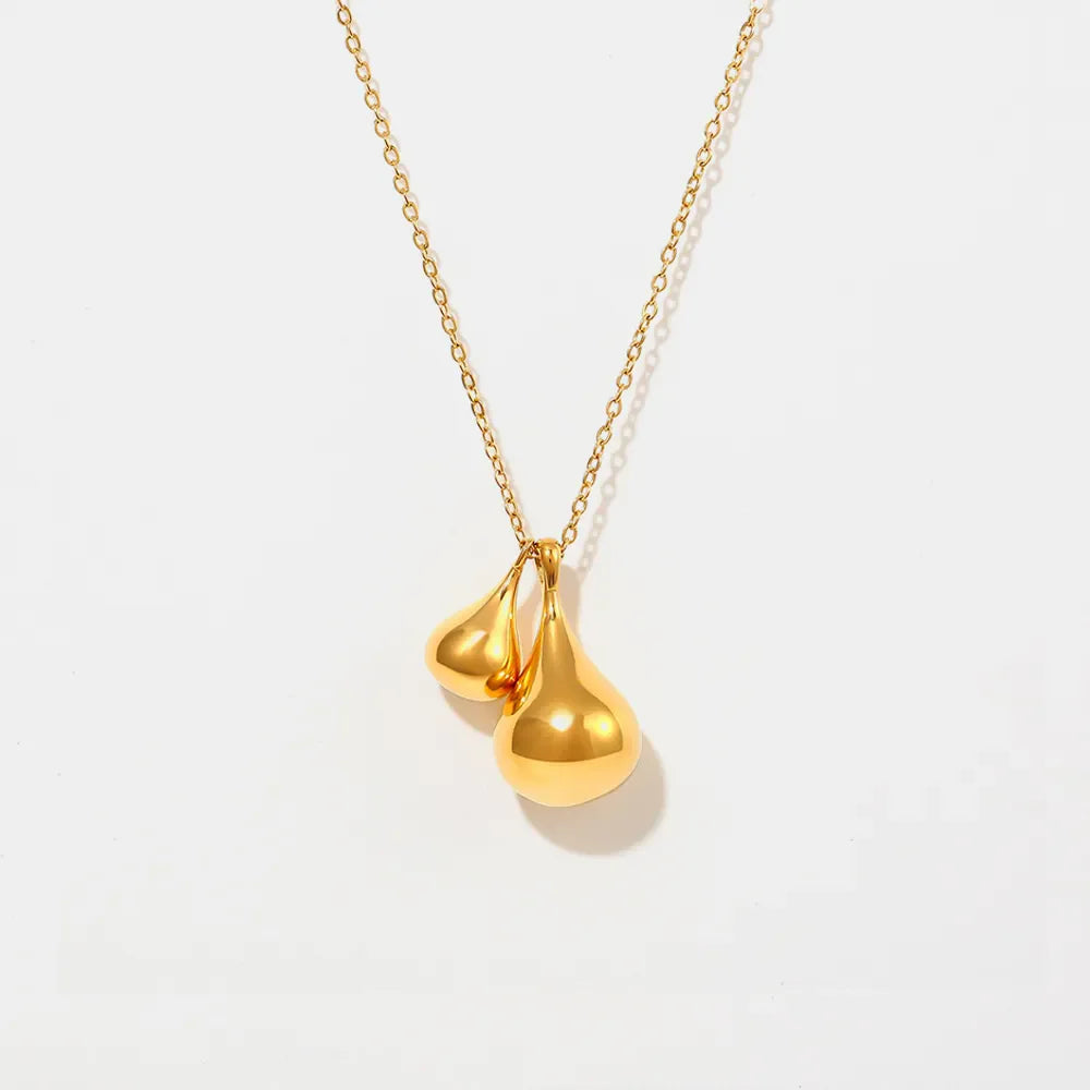 Gold necklace with two polished teardrop pendants.