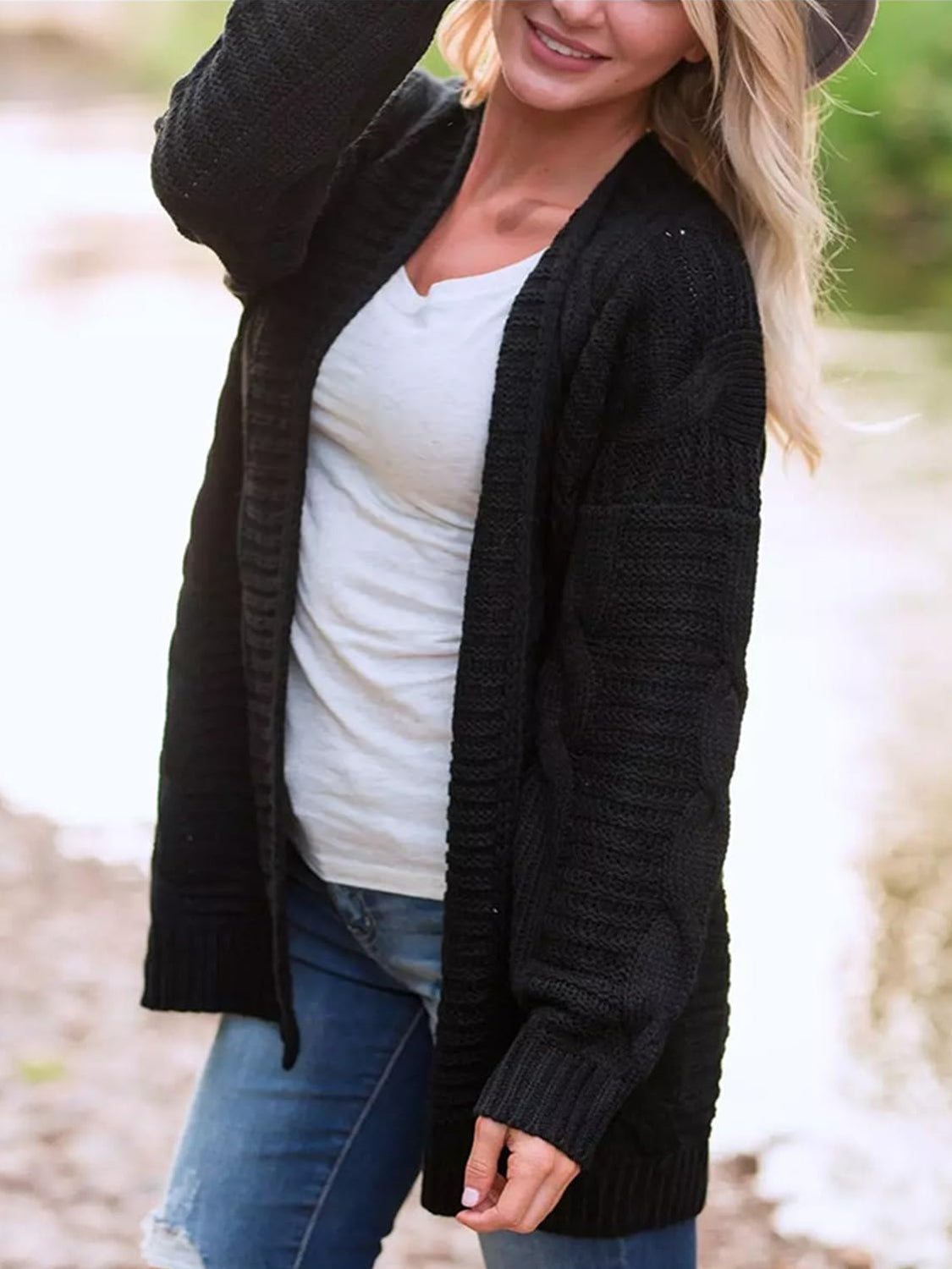Black textured cable knit duster cardigan with open front and long sleeves.