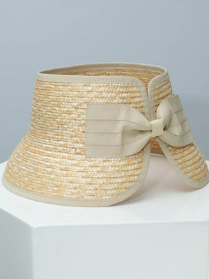 Chic straw visor hat in off-white with a decorative bow detail.