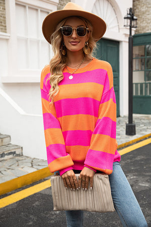 Oversized knit sweater with pink and orange stripes, balloon sleeves, and crew neck.