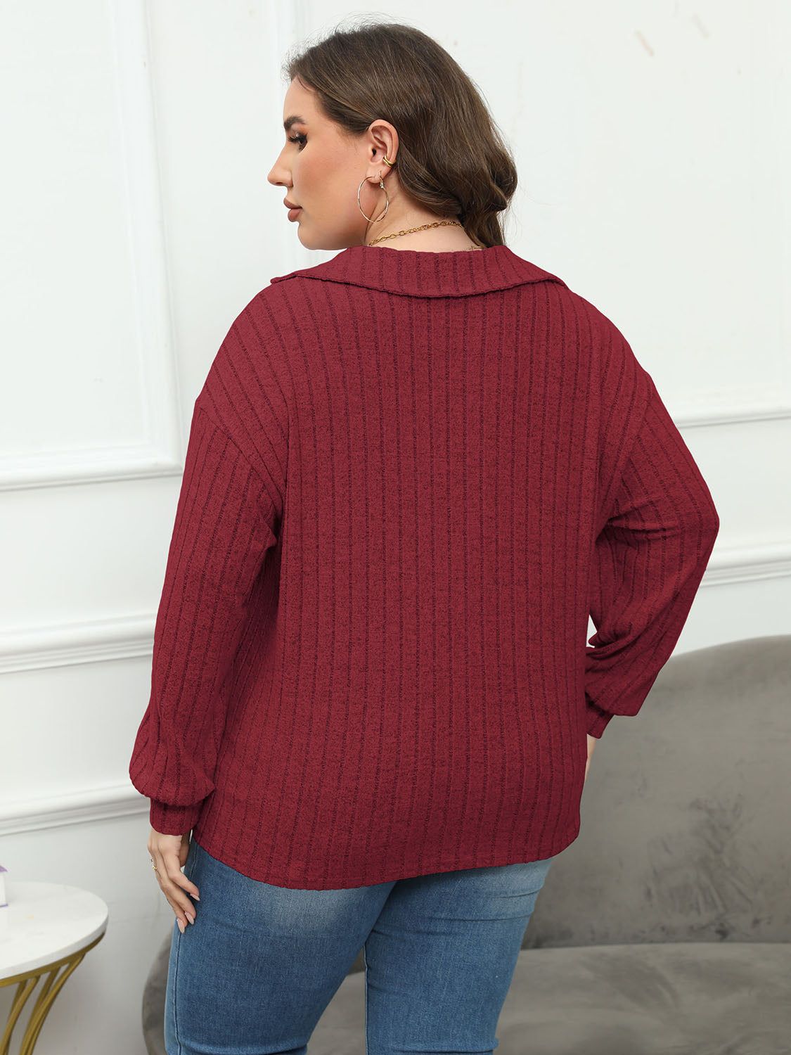 Relaxed ribbed polo top in Brick Red with a spread collar and long sleeves.