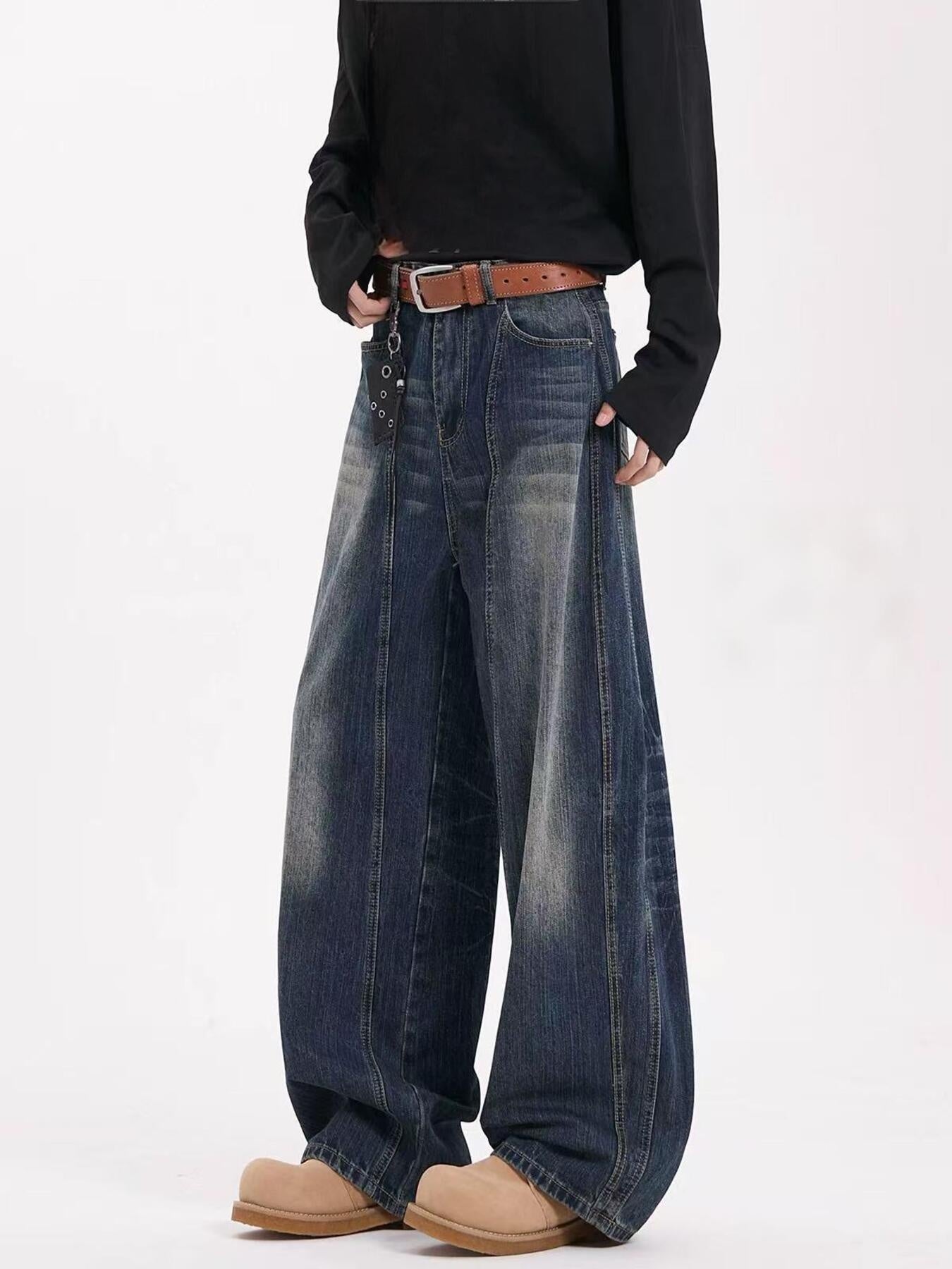 Men's dark blue vintage wide leg jeans with a belted waist and distressed wash.