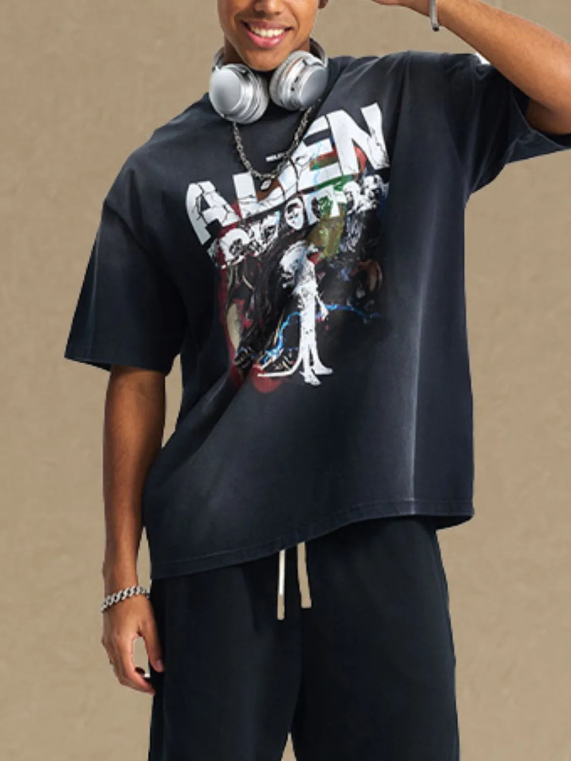 Black oversized graphic tee with alien print and short sleeves.