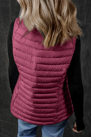 Deep Purple quilted puffer vest with horizontal quilting and side pockets.