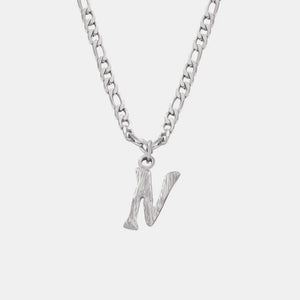 Silver initial pendant necklace with textured letter N on a figaro chain